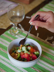 Vegan food concept: light vegetable salad for dinner, mix of red tomatos, green bean, cucumber and chick-pea. Tasty vegetarian meal.