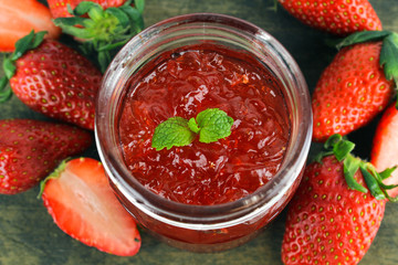 fresh strawberry jam in glass bottle with mint leaf