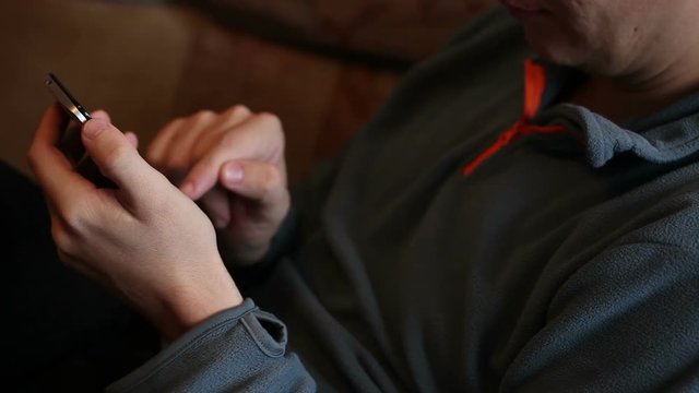man uses the phone. Hands close-up
