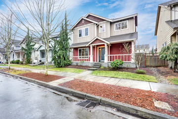 Contemporary Red and grey home exterior with covered porch