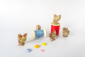  Chicks are sewing, chicken sculpture, decorate,  Decorative sculpture rooster on white background . chicken sculpture isolate. Rock sculpture of cock .