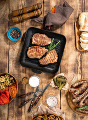 Grilled steak, grilled sausages, grilled vegetables and lager be