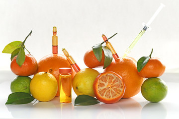 ampoules and Serum with Vitamin C. Organic cosmetics concept. Lemon,  orange, tangerine and...