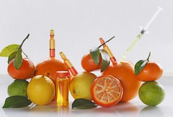 ampoules and Serum with Vitamin C. Organic cosmetics concept. Lemon, lime, orange, tangerine and...