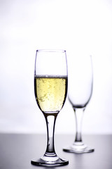 glass of white wine on a table on white background isolate