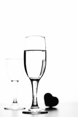 monochrome photo of champagne on white table on white background
