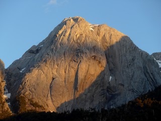 Late afternoon sun fading across the large Granite cliffs in Cochamo Valley in Southern Chile.