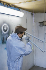 Back view of man in cap cleaning frame