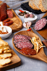Variety of salami, cheese chechil and bread.