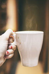 Mano sosteniendo una taza de café 