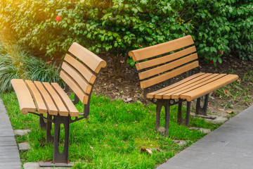 Fototapeta premium Bench in a park on sunny day in city of China.