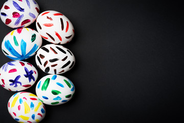 Easter eggs on a black background. Easter ideas. Easter egg. Space for text.