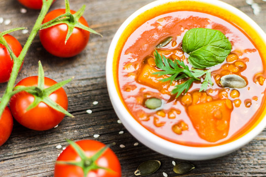 Vegetable Soup Detail with Cherry Tomatoes on Wooden Background