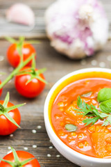 Vegetable Soup with Cherry Tomatoes and Garlic on Wooden Background