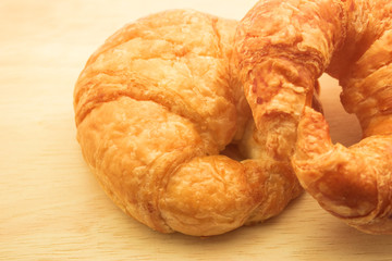 Tasty croissants on wooden background