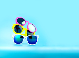 Stack of  Sunglasses in light blue studio,Summer Time concept,Le
