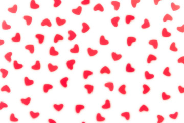 Valentine's day  decorative soft blur abstract pattern of red hearts confetti  on white background. Festive valentine backdrop.