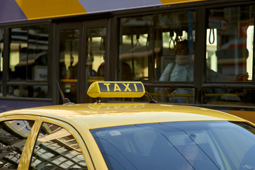 Yellow cab with taxi sign on roof