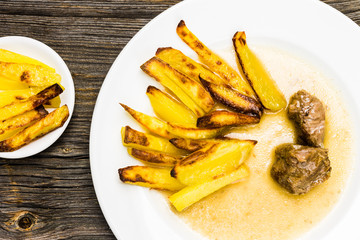 Fresh French Fries with Sauce and Meat on White Plate