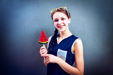 Beautiful girl with lollipop on a blue background