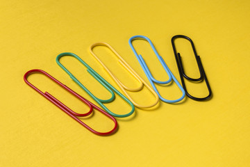 Close up of big bright multicolored paper clips with copy space for text.