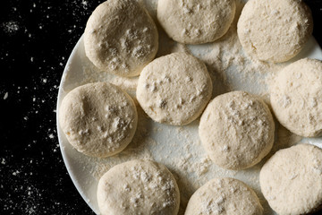 Fototapeta na wymiar Floured homemade cookies prepared for baking, top view