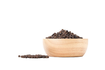 black peppercorns in wooden bowl