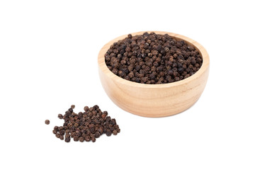 black peppercorns in wooden bowl