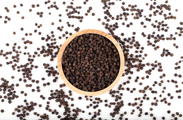 black peppercorns in wooden bowl