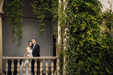 Elegant couple walking in the Italian courtyard in Lviv