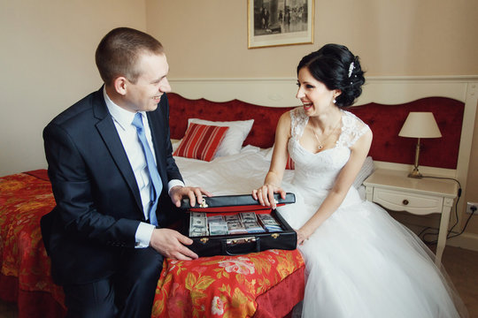 Newlyweds Open Suitcase With Money