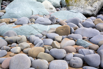 rows of blue and golden pebble on a beach in the uk