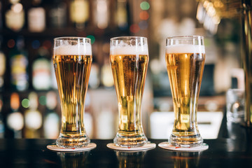 Three glasses with beers in a pub