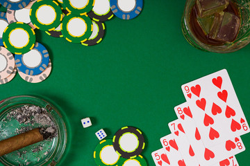 Set to playing poker with cards and chips on green background