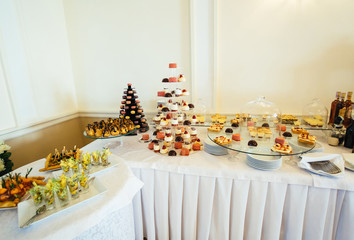 The table with cakes for guests