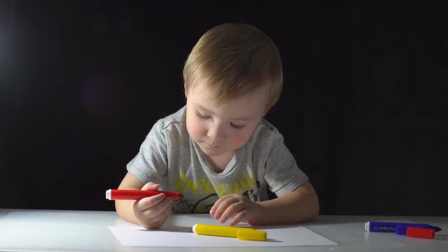 Little Boy Draws With Colored Markers