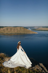 Fototapeta na wymiar Bride is on the background of river