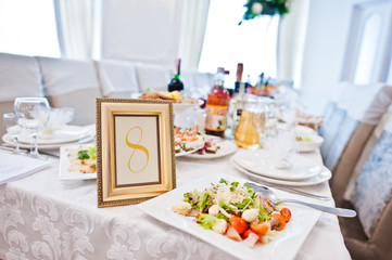 Number 8 in the frame at guest table on wedding reception.