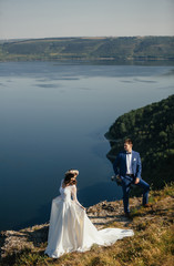 Couple in love standing on the hillside