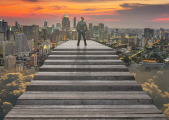 Obraz premium Businessman climbed on top of the stairs which can see top view