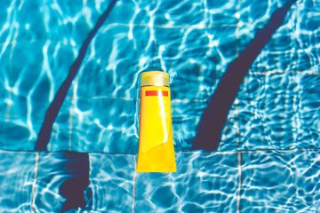 Fototapeta na wymiar Sunscreen lotion in swimming pool