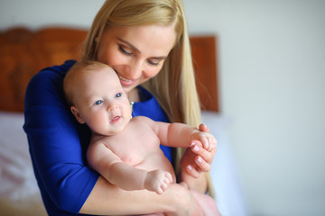 happy mother with the newborn on hands