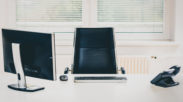 Modern Empty Office Space Desk With Computer, Phone And Chair.