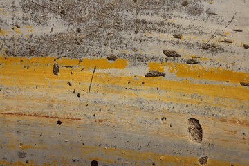 Grey painted wood with yellow stripes. Horizontal 3:2 format.