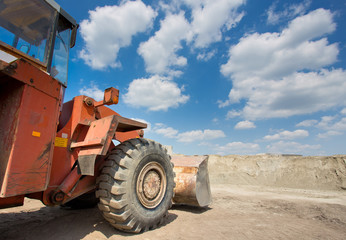 Bulldozer in front of sand pile