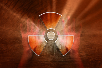 Conceptual shiny radioactive symbol with human hands on the grunge orange red colored illustration background.