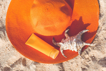Jar of sunscreen lotion on the sandy beach