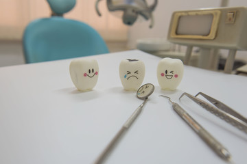 Model toys teeth and equipment in Dental room background.