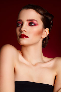 Portrait of beautiful sexy fashion model with red make up over r
