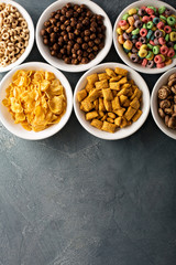 Variety of cold cereals in white bowls